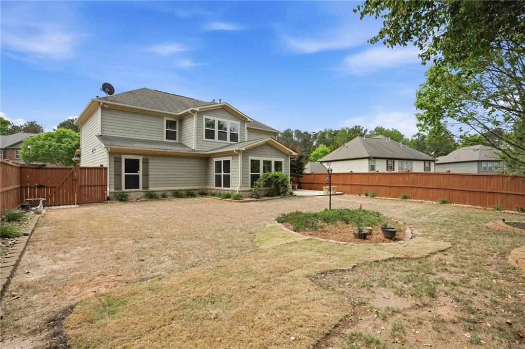 3770 Terrasol Trail Southwest Lilburn, GA 30047 - Photo 41 of 63 a front view of a house with a yard