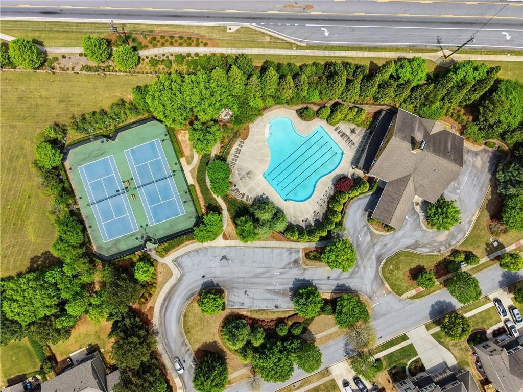 3770 Terrasol Trail Southwest Lilburn, GA 30047 - Photo 50 of 63 an aerial view of a swimming pool with outdoor seating and yard