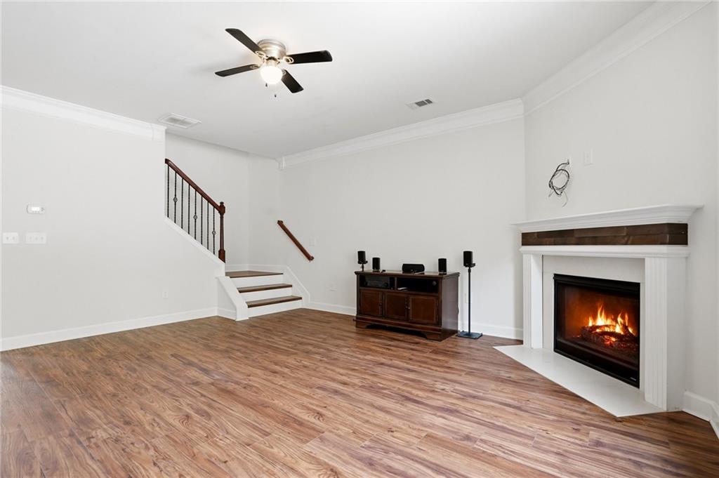 3770 Terrasol Trail Southwest Lilburn, GA 30047 - Photo 6 of 63 a view of an empty room with furniture wooden floor fire place and windows