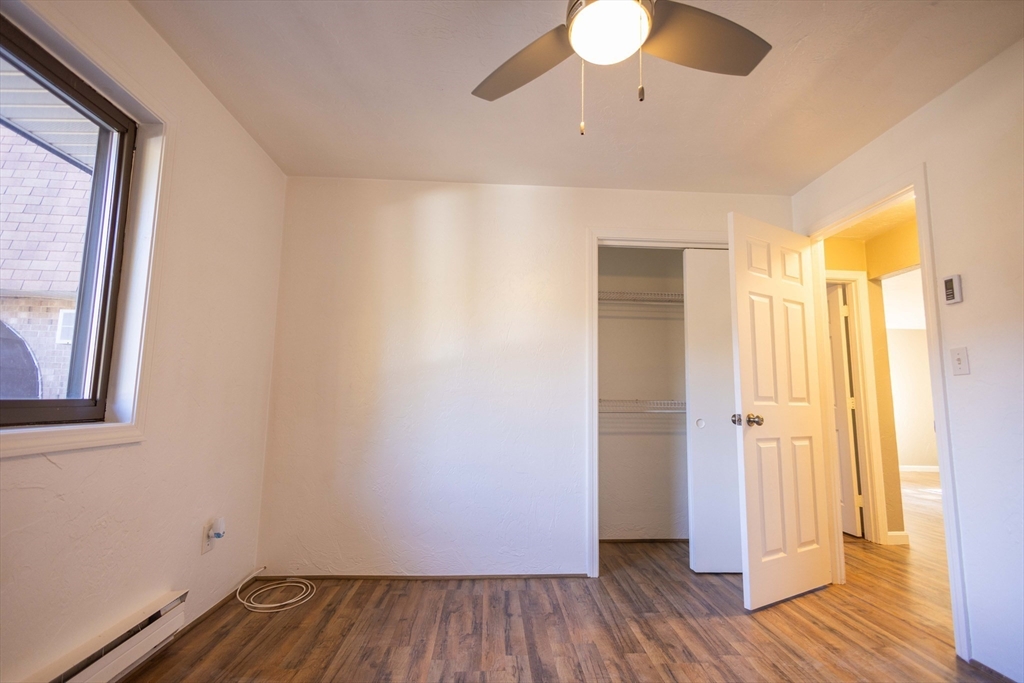 21 Erick Road, Unit 16 Mansfield, MA 02048 - Photo 11 of 28 a view of a room with wooden floor and a window