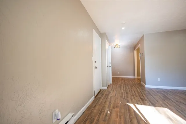 a view of hallway with wooden floor