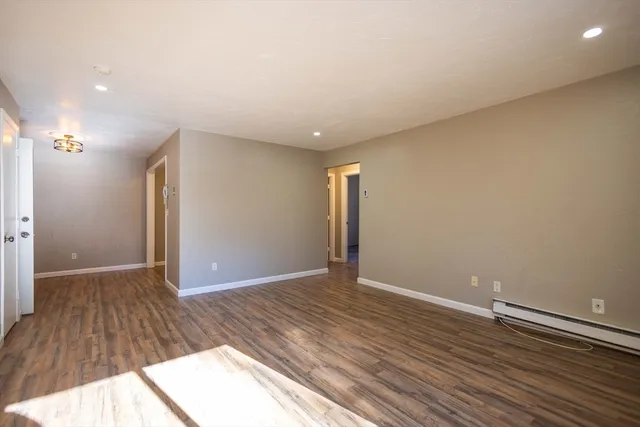 a view of an empty room and wooden floor