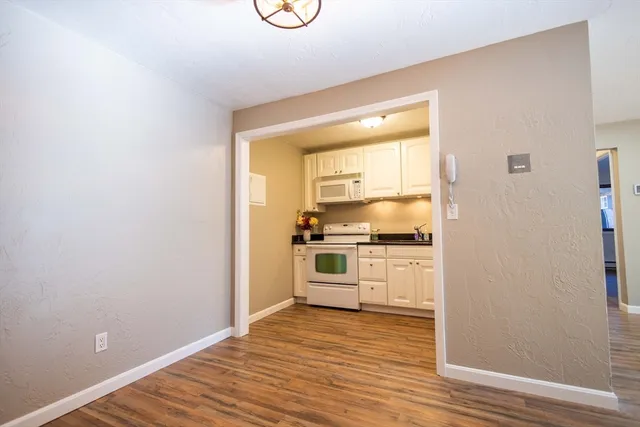 a kitchen with a refrigerator and a stove