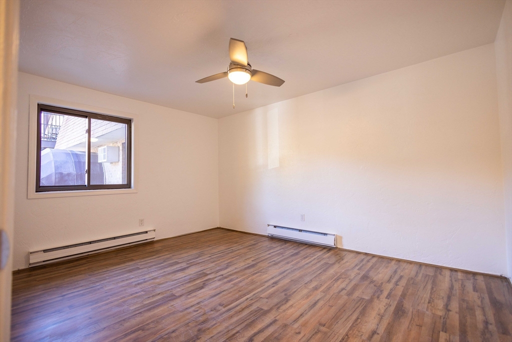 21 Erick Road, Unit 16 Mansfield, MA 02048 - Photo 5 of 28 wooden floor in an empty room with a window