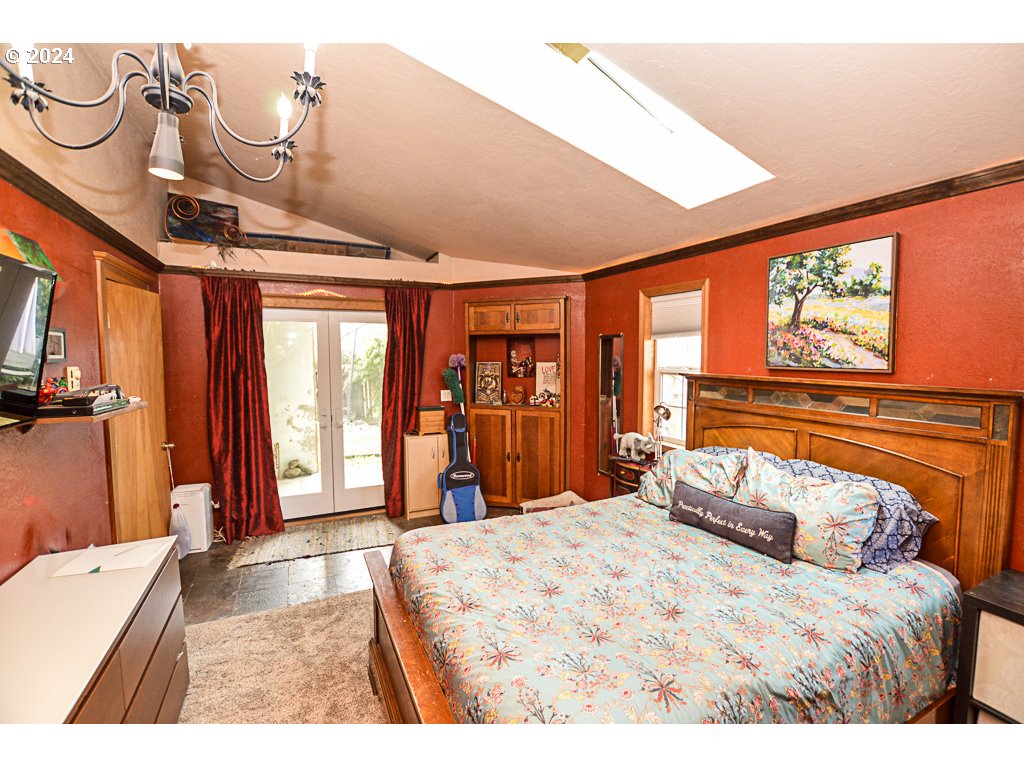 251 18th Street Springfield, OR 97477 - Photo 15 of 26 a bedroom with a large bed and a window