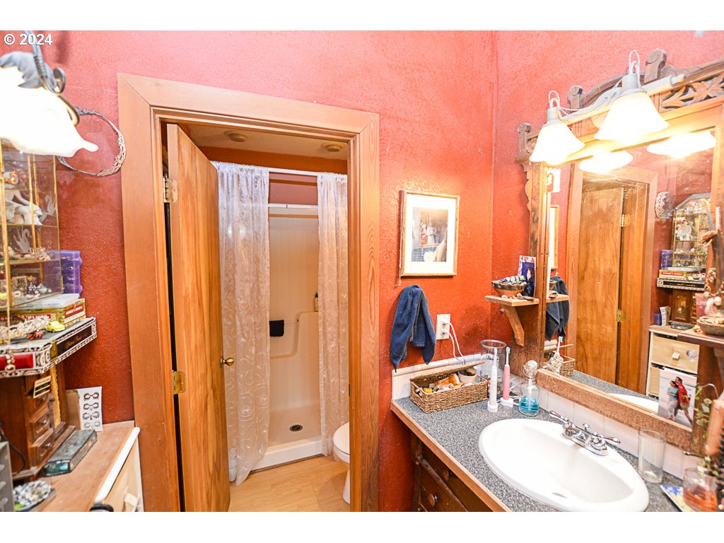 251 18th Street Springfield, OR 97477 - Photo 16 of 26 a bathroom with a sink vanity granite and a mirror
