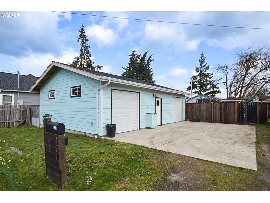 251 18th Street Springfield, OR 97477 - Photo 2 of 26 a backyard of a house with table and chairs