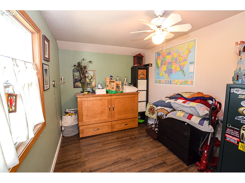 251 18th Street Springfield, OR 97477 - Photo 21 of 26 a bedroom with a bed and wooden floor