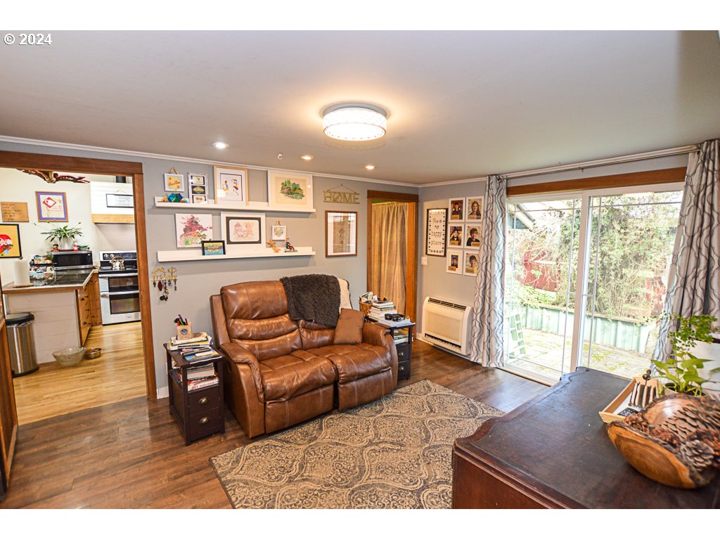 251 18th Street Springfield, OR 97477 - Photo 22 of 26 a living room with furniture and a flat screen tv