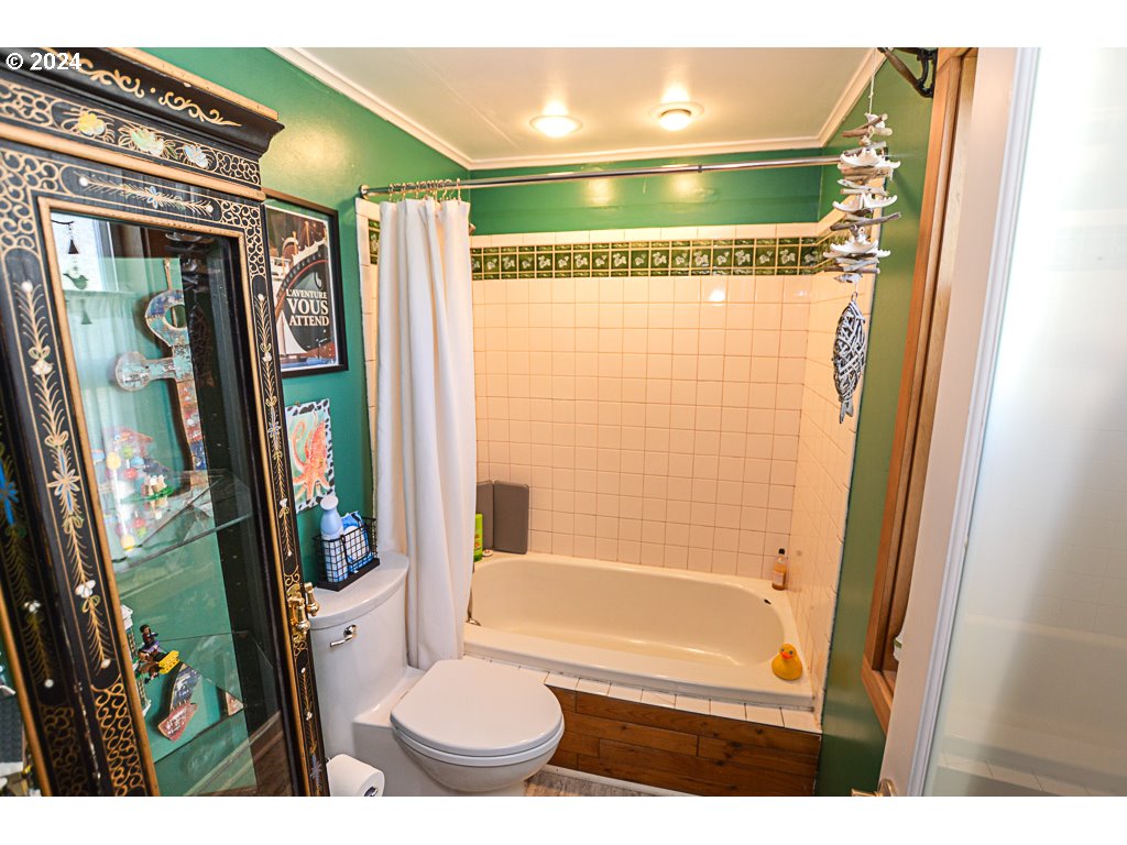 251 18th Street Springfield, OR 97477 - Photo 24 of 26 a bathroom with a toilet and a shower