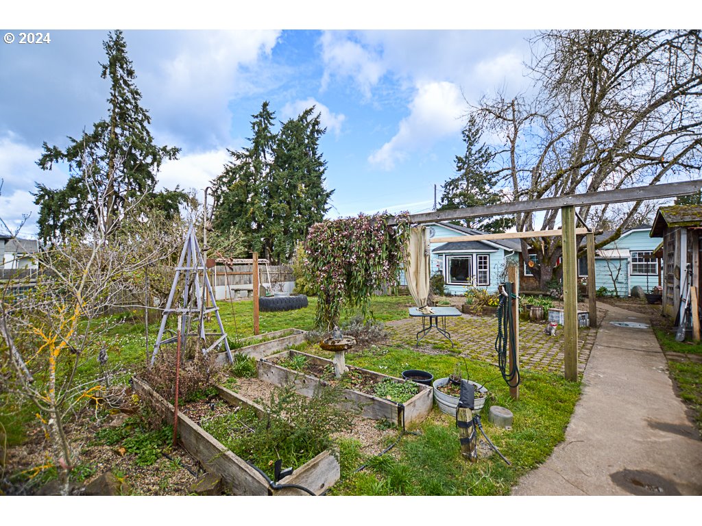 251 18th Street Springfield, OR 97477 - Photo 4 of 26 a backyard of a house with table and chairs