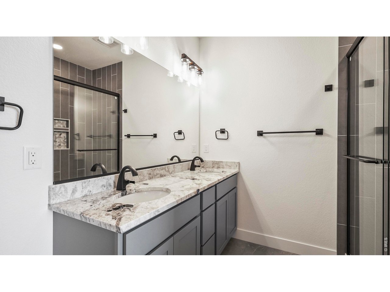448 Cache Avenue Fort Morgan, CO 80701 - Photo 16 of 43 a bathroom with a sink vanity and a mirror