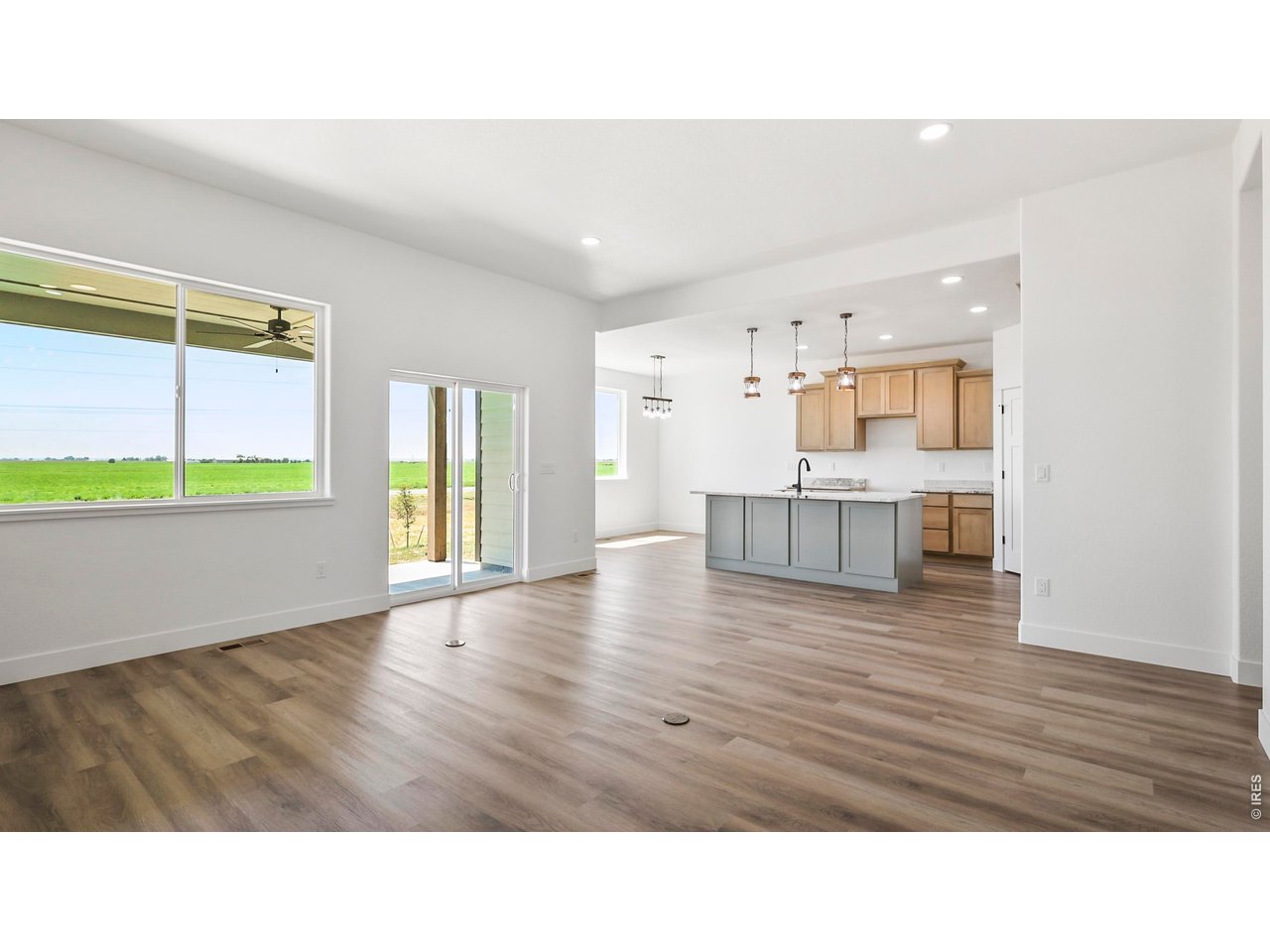 448 Cache Avenue Fort Morgan, CO 80701 - Photo 8 of 43 a room with kitchen island stainless steel appliances wooden floor and window