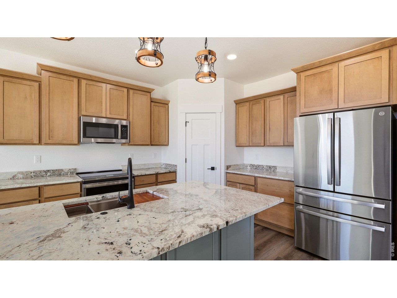 448 Cache Avenue Fort Morgan, CO 80701 - Photo 10 of 43 a kitchen with stainless steel appliances granite countertop a refrigerator and a stove top oven