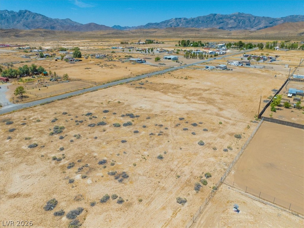 4610 Lawrence Road Pahrump, NV 89048 - Photo 25 of 42 A vast, open desert landscape provides a serene backdrop with distant mountains and scattered homes.