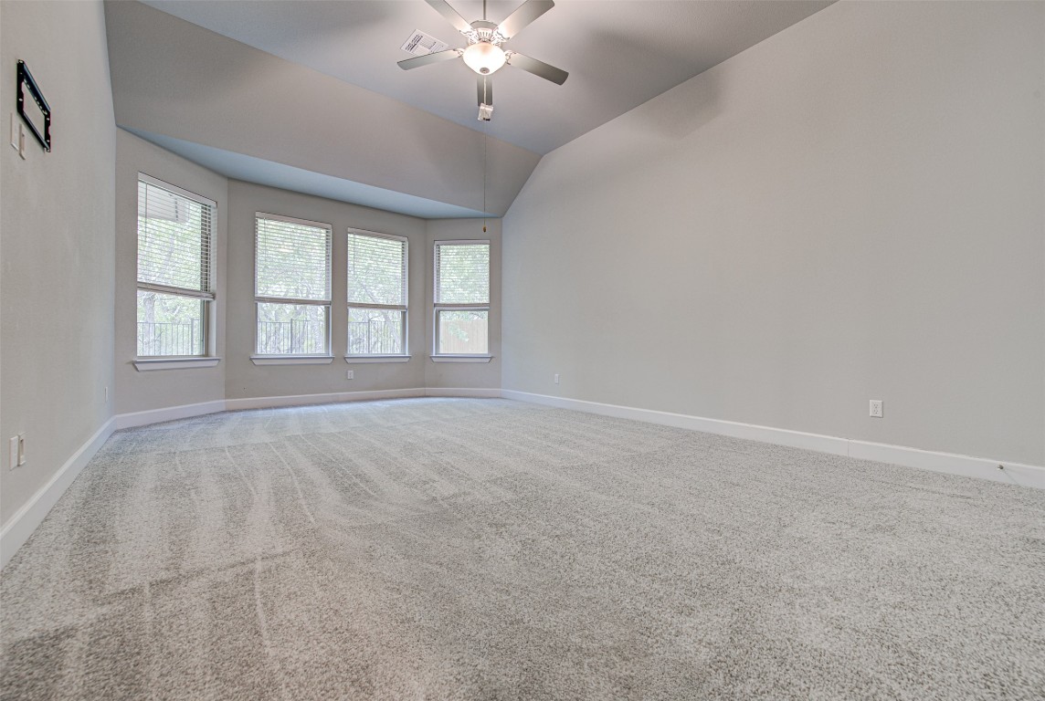 316 Buffalo Ridge Drive Manchaca, TX 78652 - Photo 13 of 37 an empty room with chandelier fan and windows