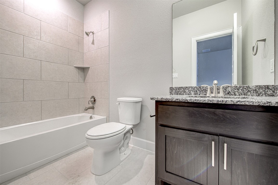 316 Buffalo Ridge Drive Manchaca, TX 78652 - Photo 21 of 37 a bathroom with a granite countertop toilet sink and mirror