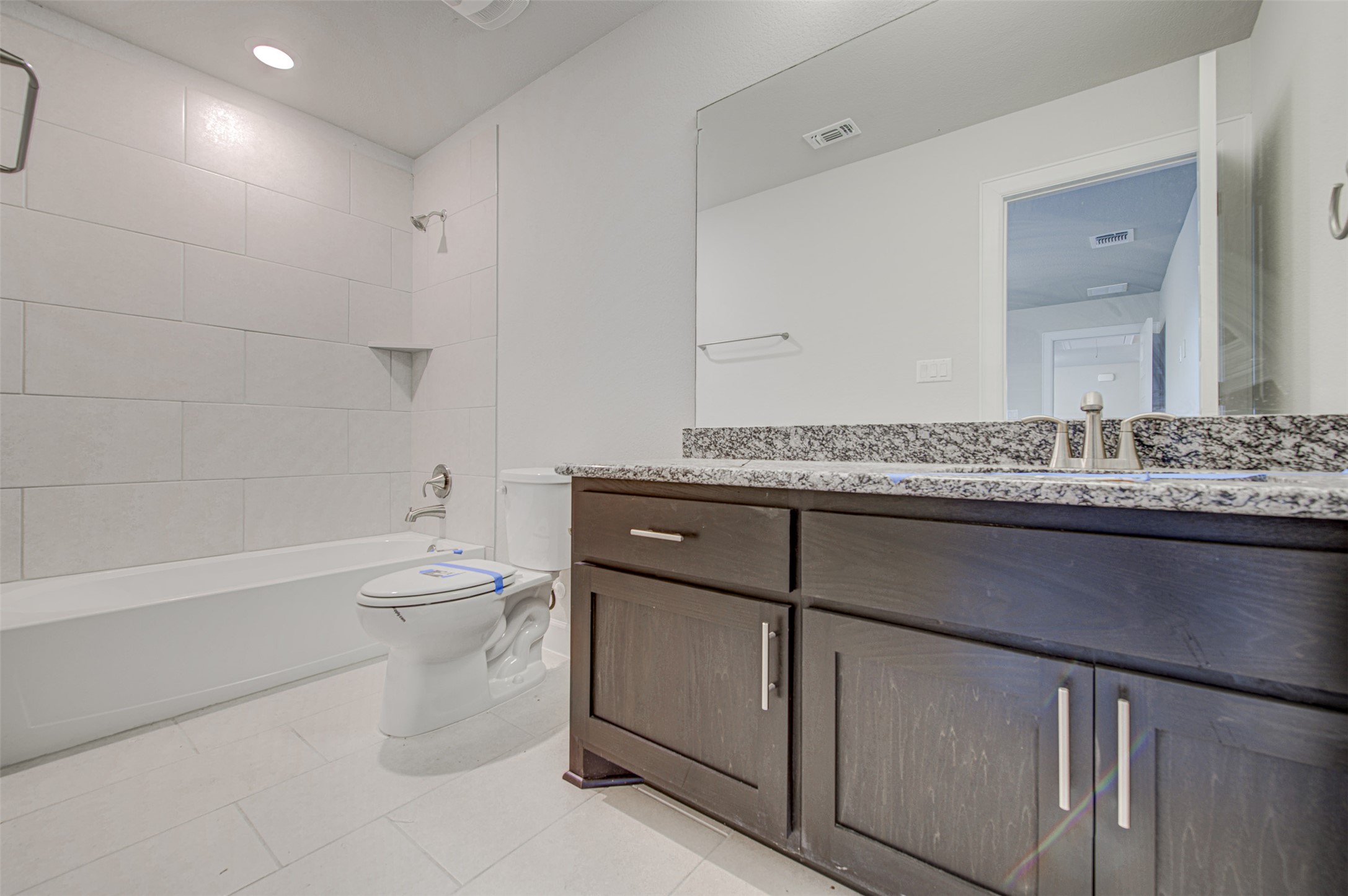 316 Buffalo Ridge Drive Manchaca, TX 78652 - Photo 24 of 37 a bathroom with a granite countertop sink a toilet and bathtub