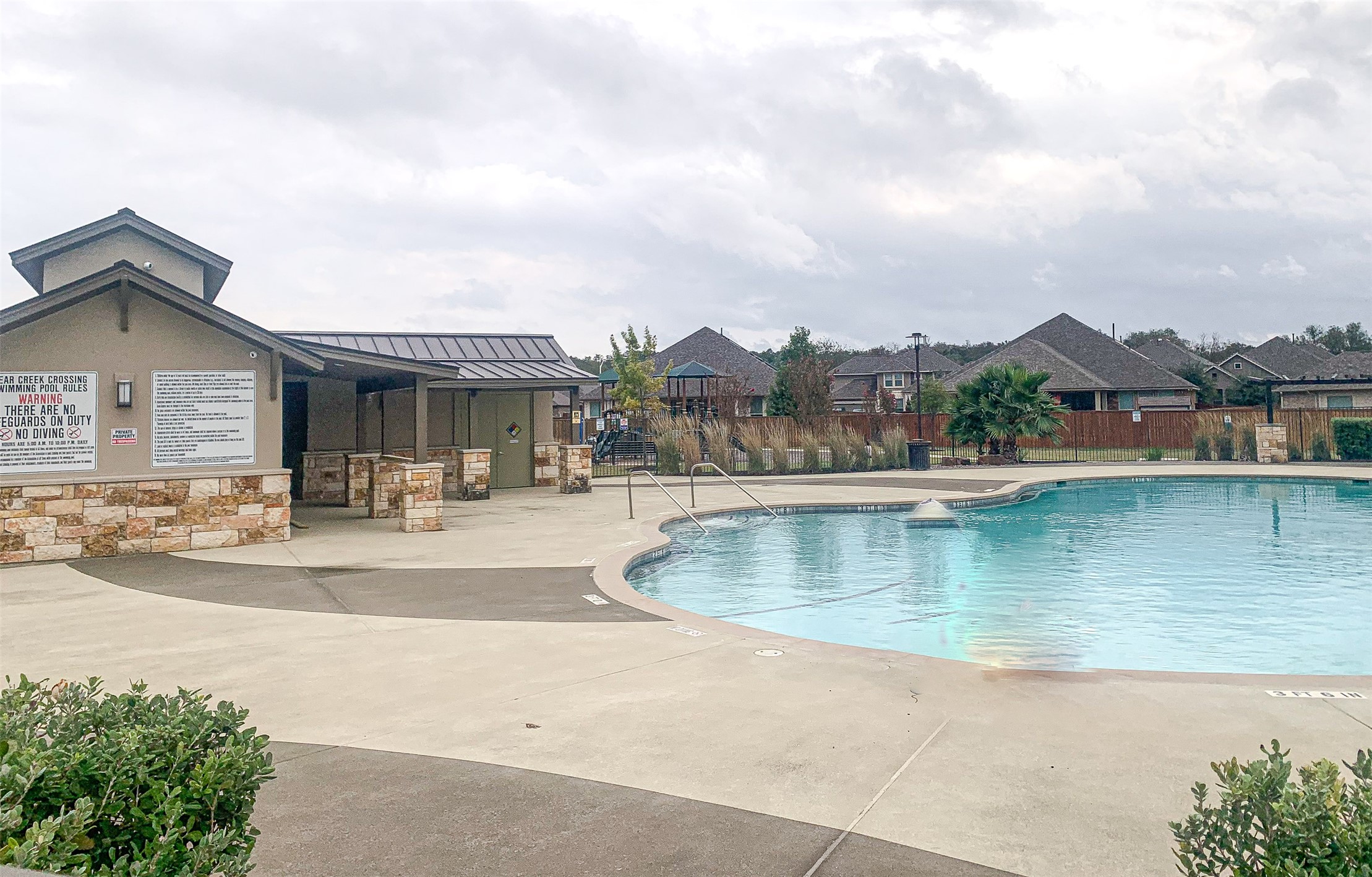 316 Buffalo Ridge Drive Manchaca, TX 78652 - Photo 37 of 37 a view of a swimming pool and a fountain in front of house