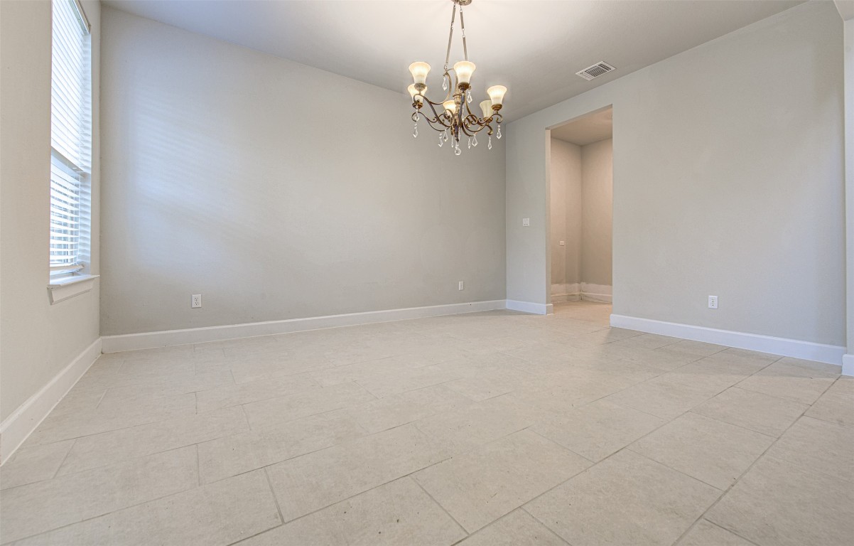 316 Buffalo Ridge Drive Manchaca, TX 78652 - Photo 4 of 37 en empty room with windows and chandelier