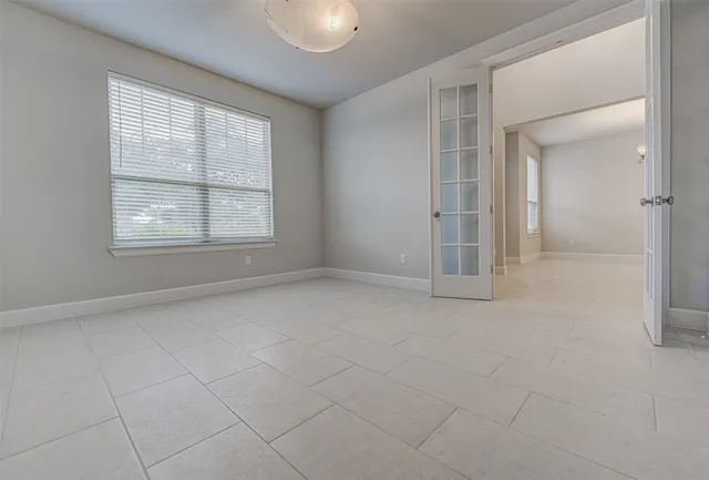 an empty room with windows and closet