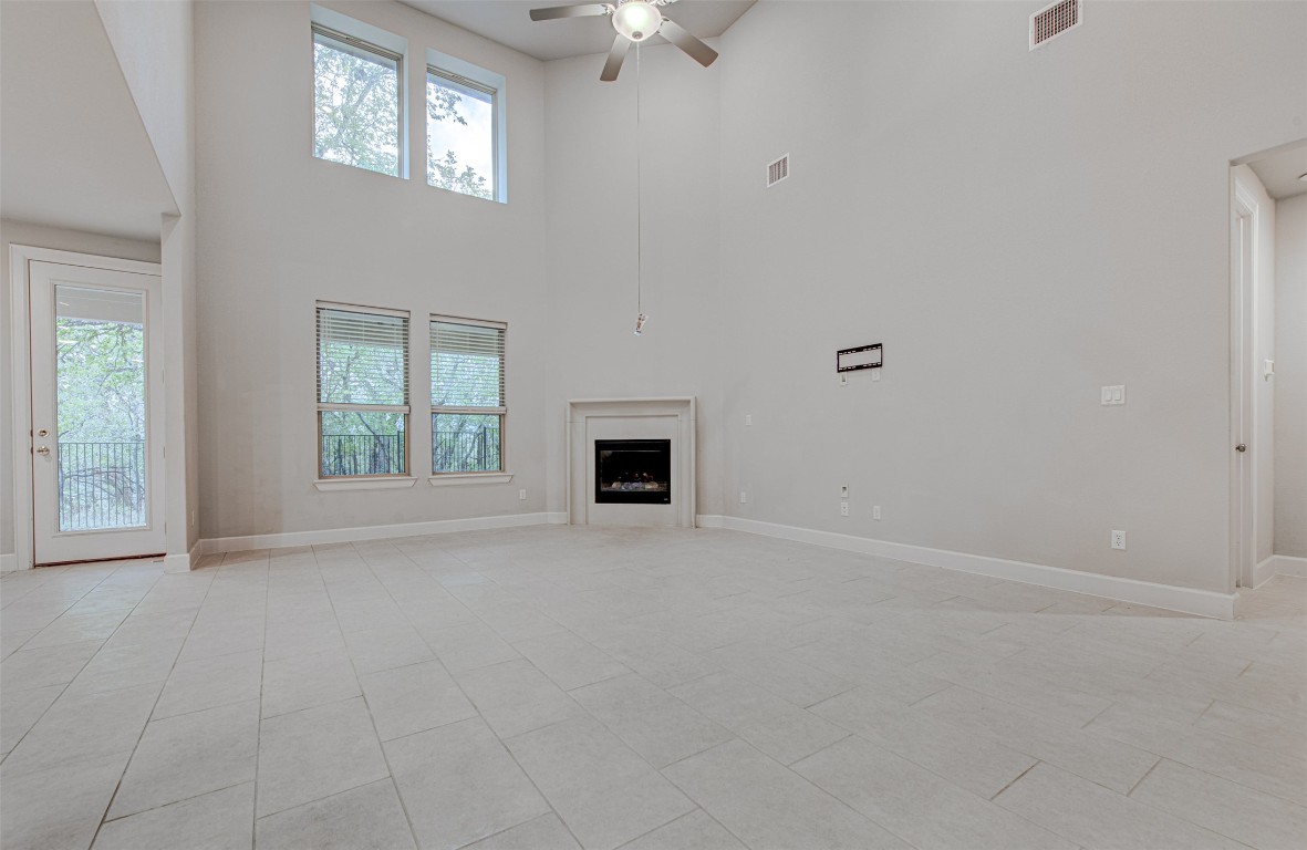 316 Buffalo Ridge Drive Manchaca, TX 78652 - Photo 7 of 37 an empty room with windows and fireplace