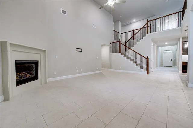 a view of entryway and hall with a fireplace