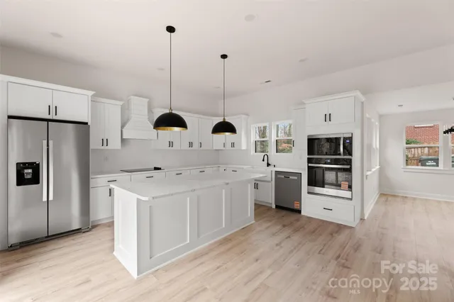 a kitchen with stainless steel appliances a stove refrigerator sink and oven