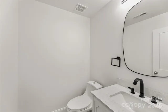 a bathroom with a sink mirror and toilet