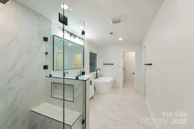 a bathroom with a double vanity sink toilet and shower