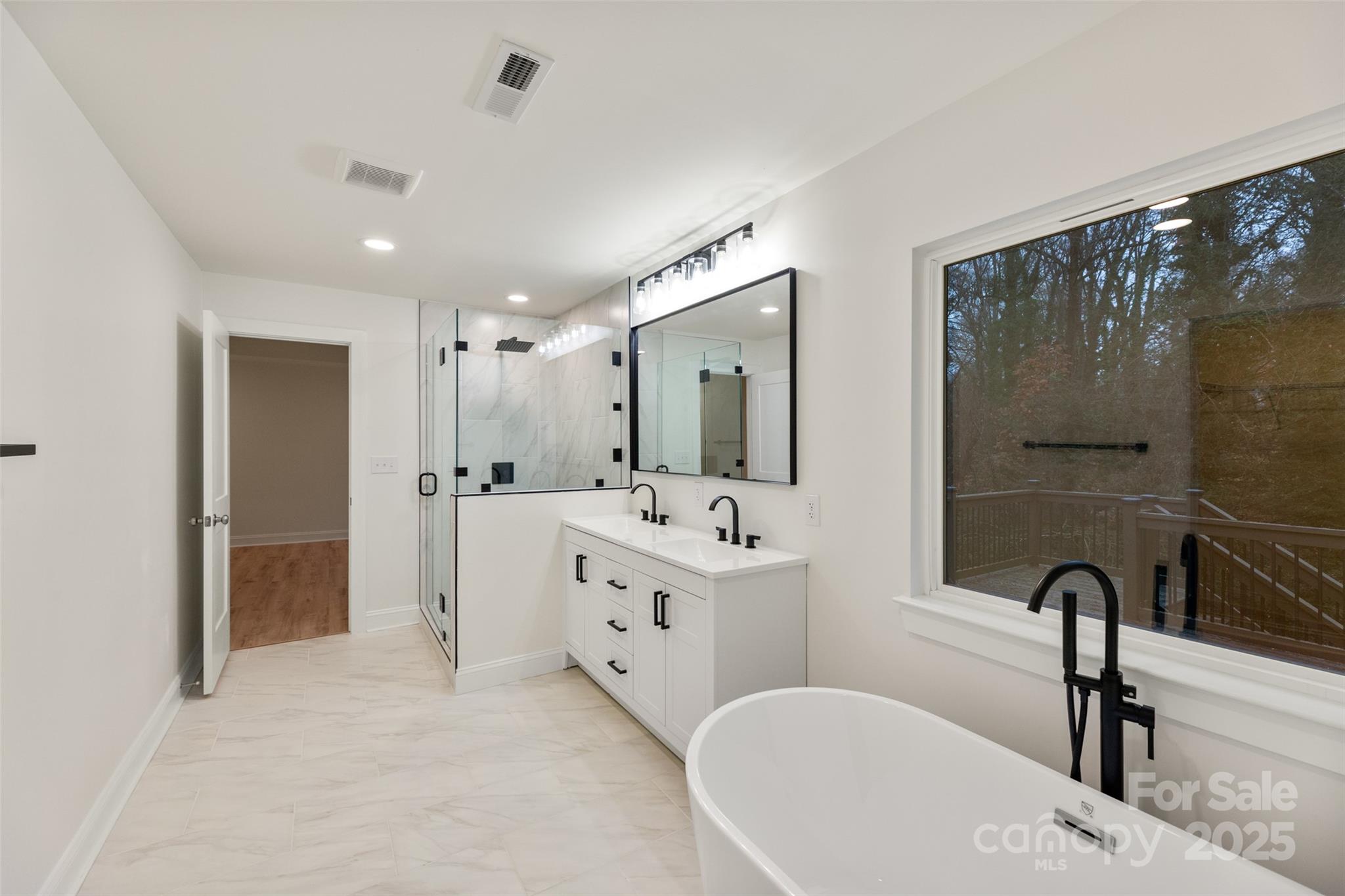 3021 Whitson Road Gastonia, NC 28054 - Photo 23 of 31 a bathroom with a double vanity sink a mirror and a bathtub
