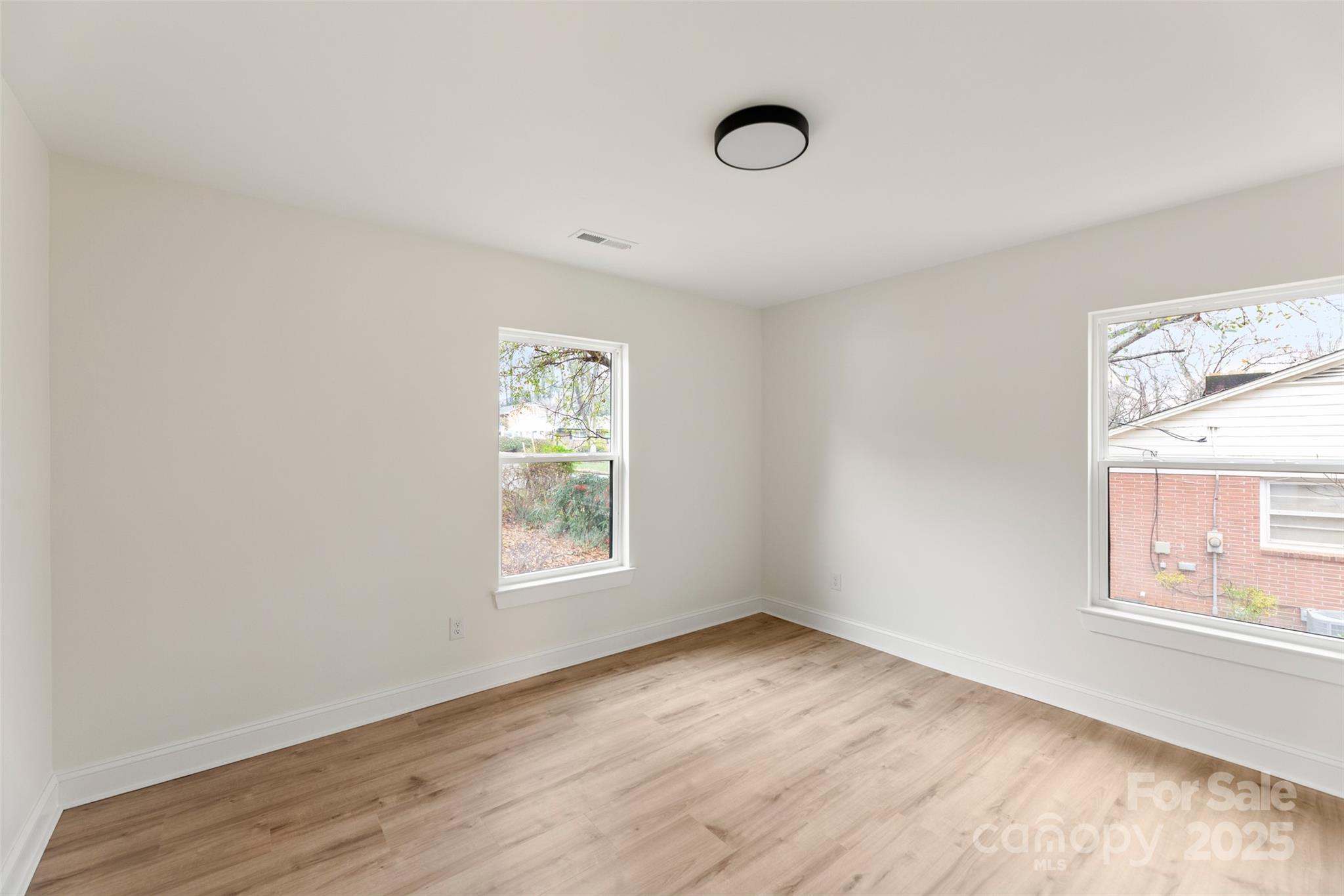 3021 Whitson Road Gastonia, NC 28054 - Photo 25 of 31 an empty room with wooden floor and windows
