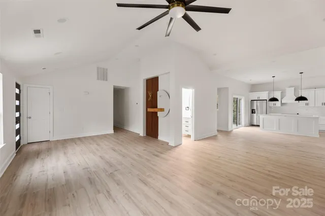 a view of empty room with wooden floor and window