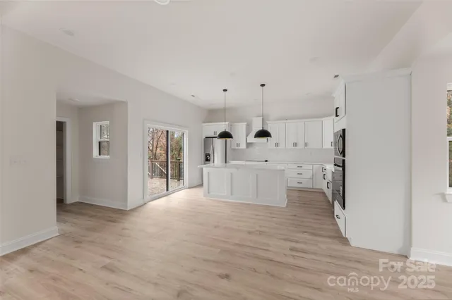 a large white room with kitchen island