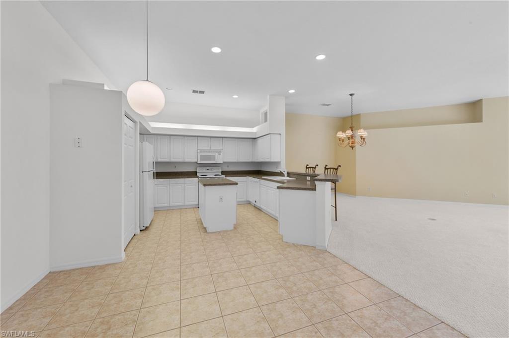 23851 Amalfi Coast Road Estero, FL 34135 - Photo 11 of 49 a view of kitchen with wooden floor