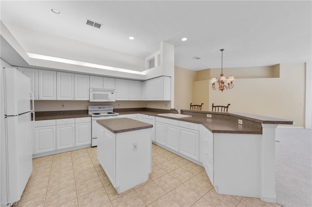 23851 Amalfi Coast Road Estero, FL 34135 - Photo 13 of 49 a kitchen with a sink and cabinets