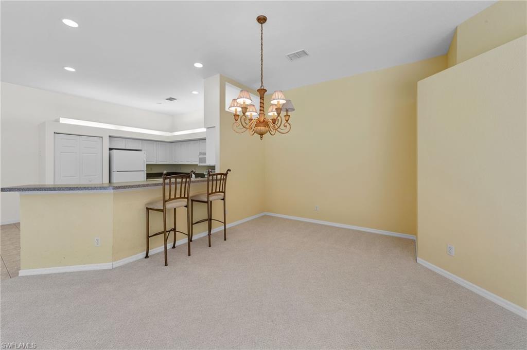 23851 Amalfi Coast Road Estero, FL 34135 - Photo 20 of 49 a view of a kitchen with a table and chairs