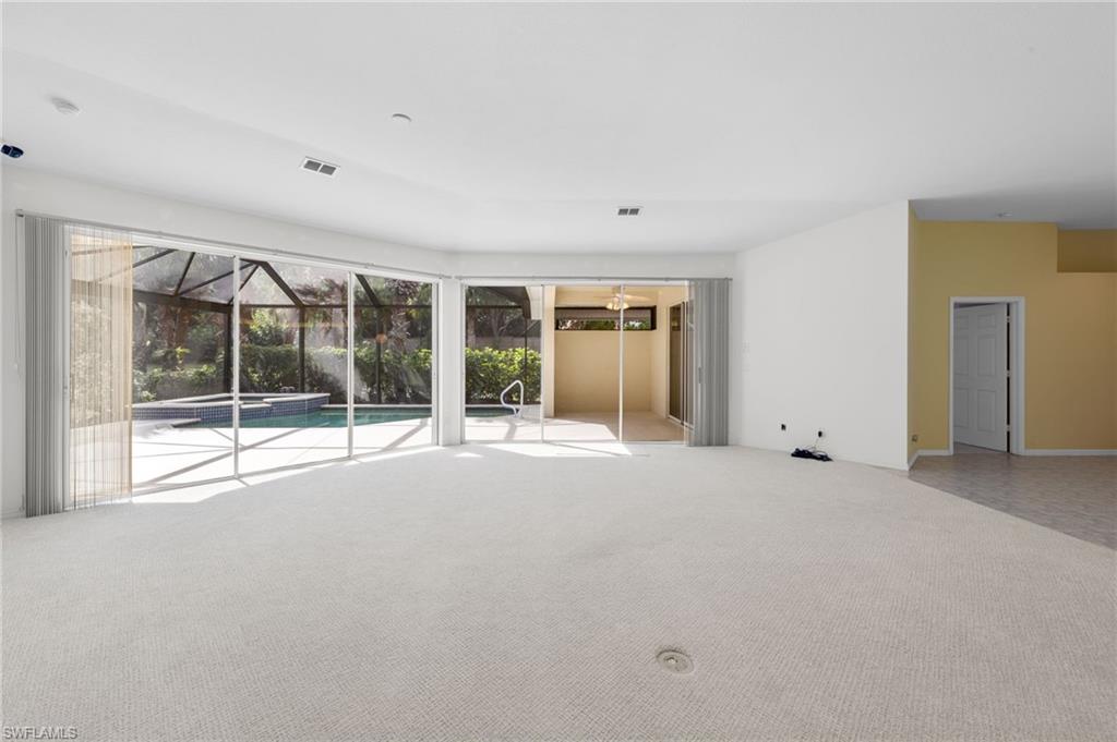 23851 Amalfi Coast Road Estero, FL 34135 - Photo 21 of 49 a view of an empty room with glass door