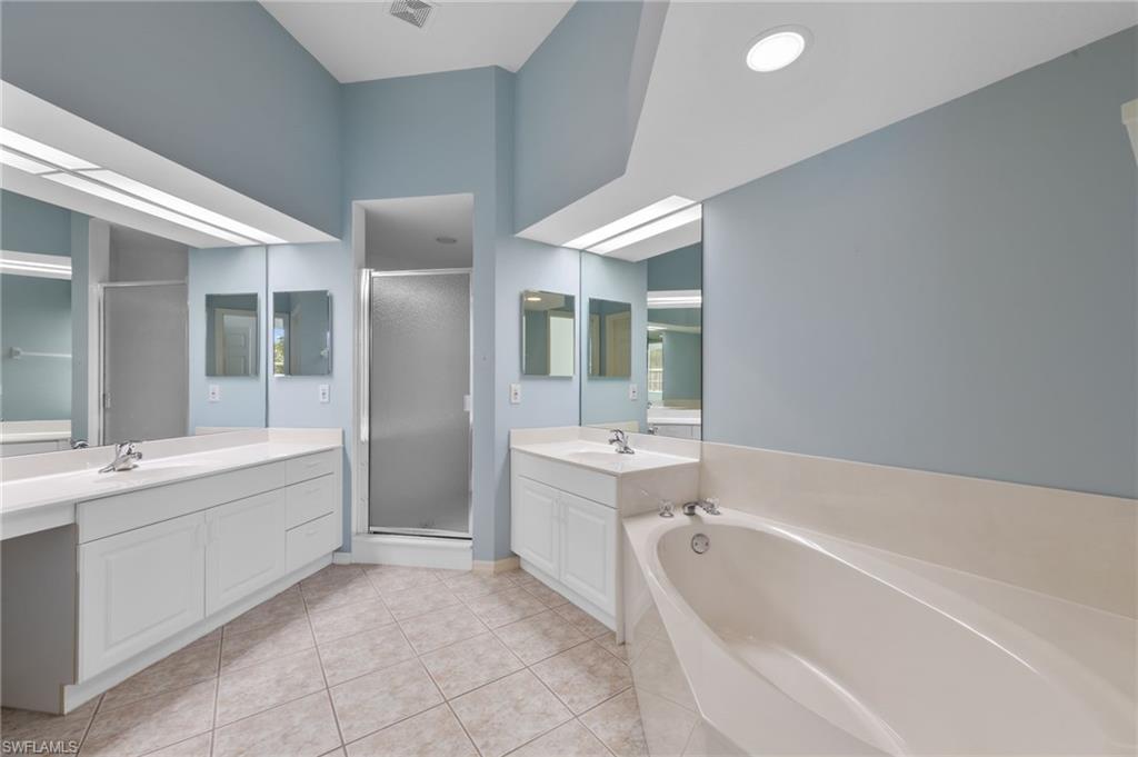 23851 Amalfi Coast Road Estero, FL 34135 - Photo 26 of 49 a bathroom with a bathtub and a sink