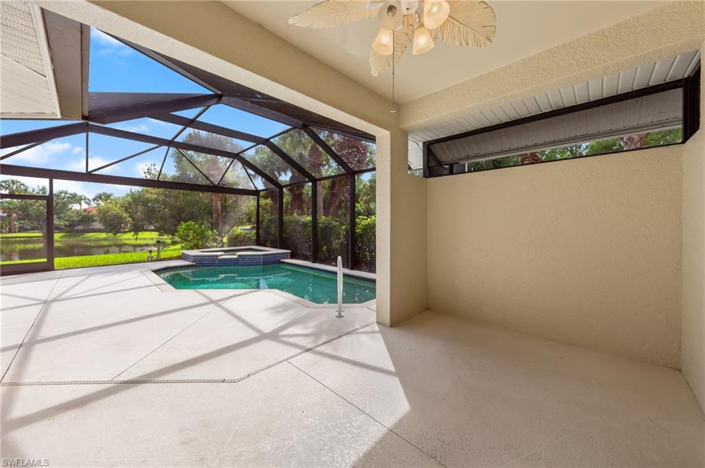 23851 Amalfi Coast Road Estero, FL 34135 - Photo 33 of 49 a view of a patio with a table and chairs under an umbrella