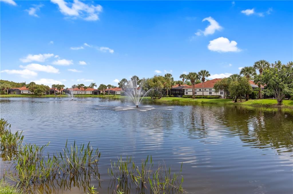 23851 Amalfi Coast Road Estero, FL 34135 - Photo 39 of 49 a view of a lake with houses in the back