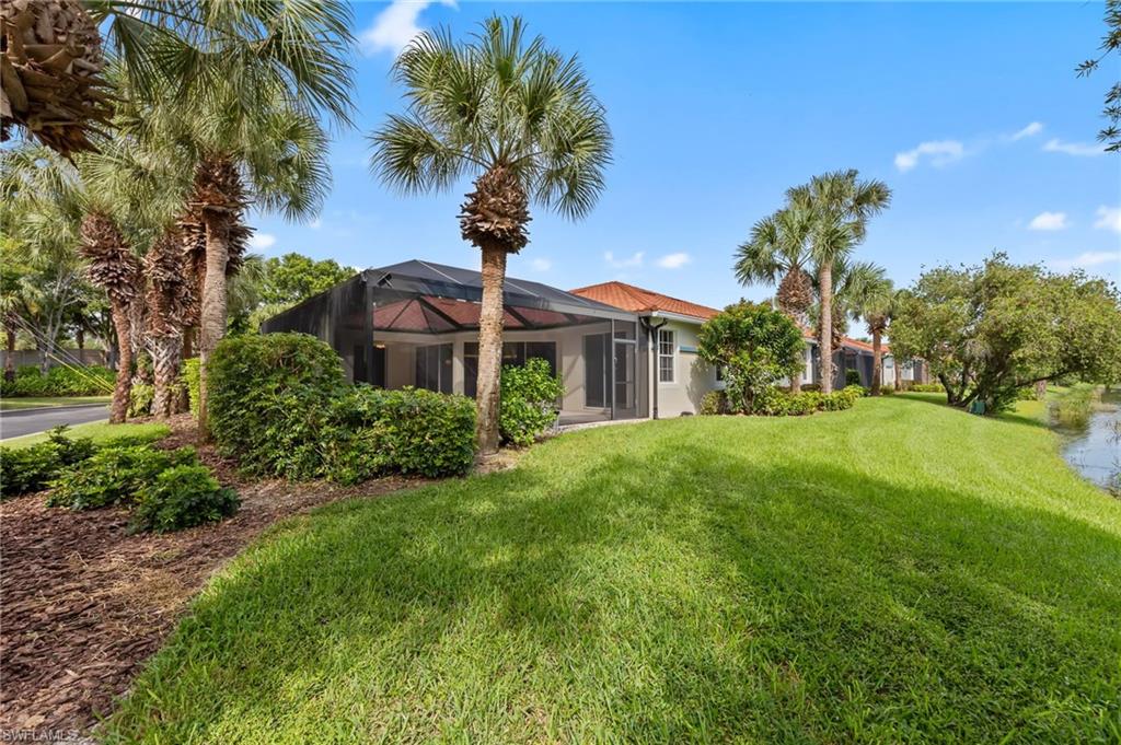 23851 Amalfi Coast Road Estero, FL 34135 - Photo 41 of 49 a front view of a house with garden