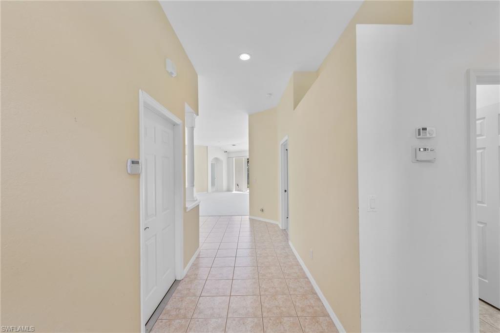 23851 Amalfi Coast Road Estero, FL 34135 - Photo 6 of 49 a view of a hallway with a white walls