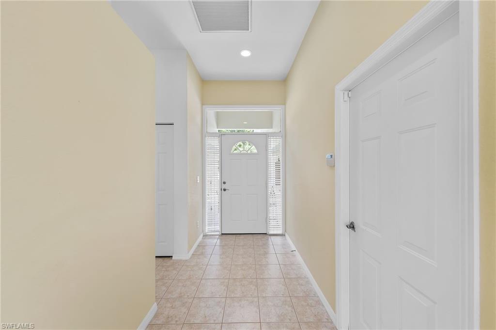 23851 Amalfi Coast Road Estero, FL 34135 - Photo 7 of 49 a view of a hallway with a glass door