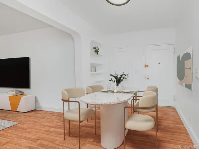 a dining room with furniture and wooden floor