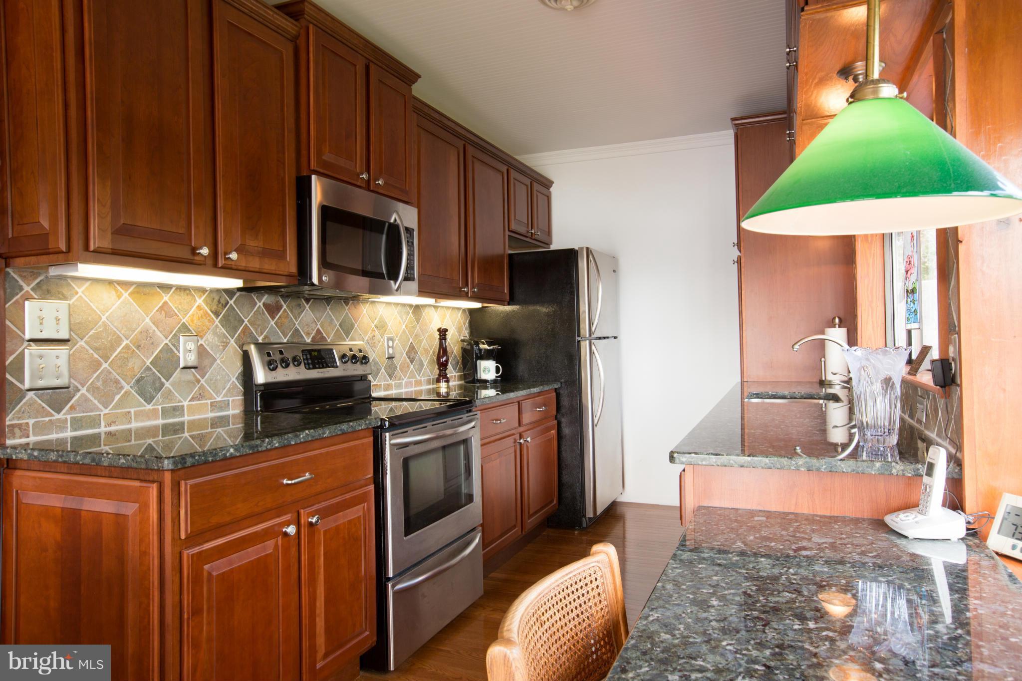 100 Ridge Road Riva, MD 21140 - Photo 16 of 29 a kitchen with stainless steel appliances granite countertop a stove a sink dishwasher and a refrigerator