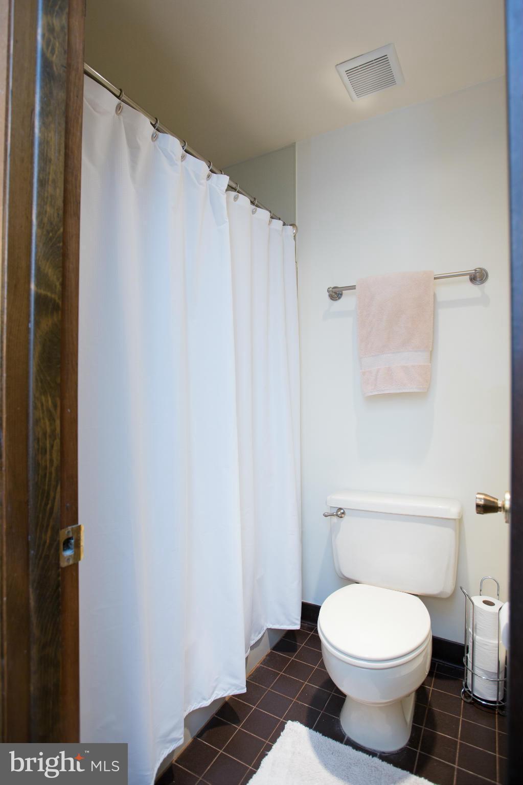 100 Ridge Road Riva, MD 21140 - Photo 26 of 29 a white toilet sitting next to a shower curtain