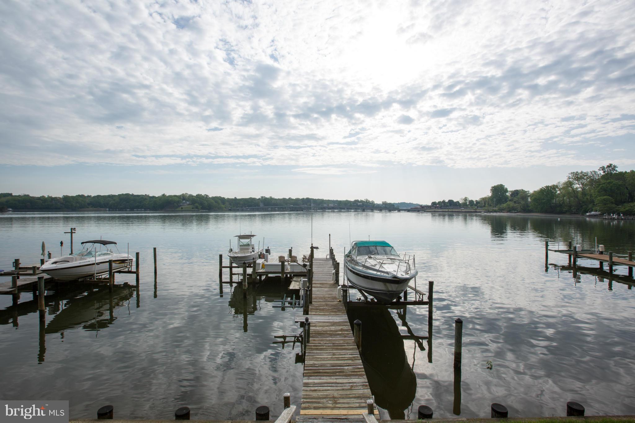 100 Ridge Road Riva, MD 21140 - Photo 6 of 29 a view of a lake with a table and chairs next to a yard