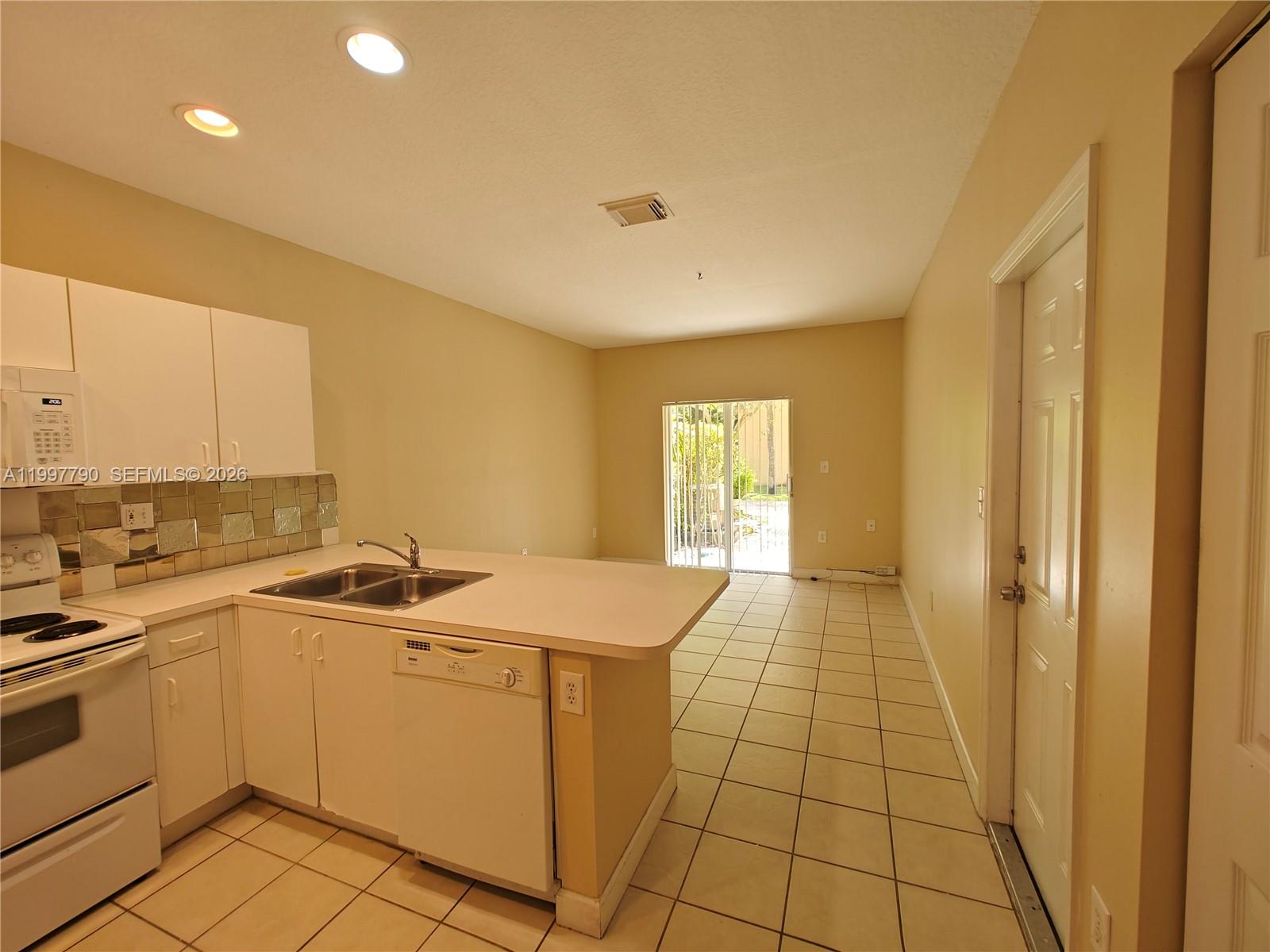 11252 Southwest 230th Terrace, Unit 11252 Miami, FL 33170 - Photo 5 of 28 a room with a sink and cabinets