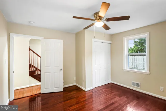 a view of an entryway with wooden floor and a workspace